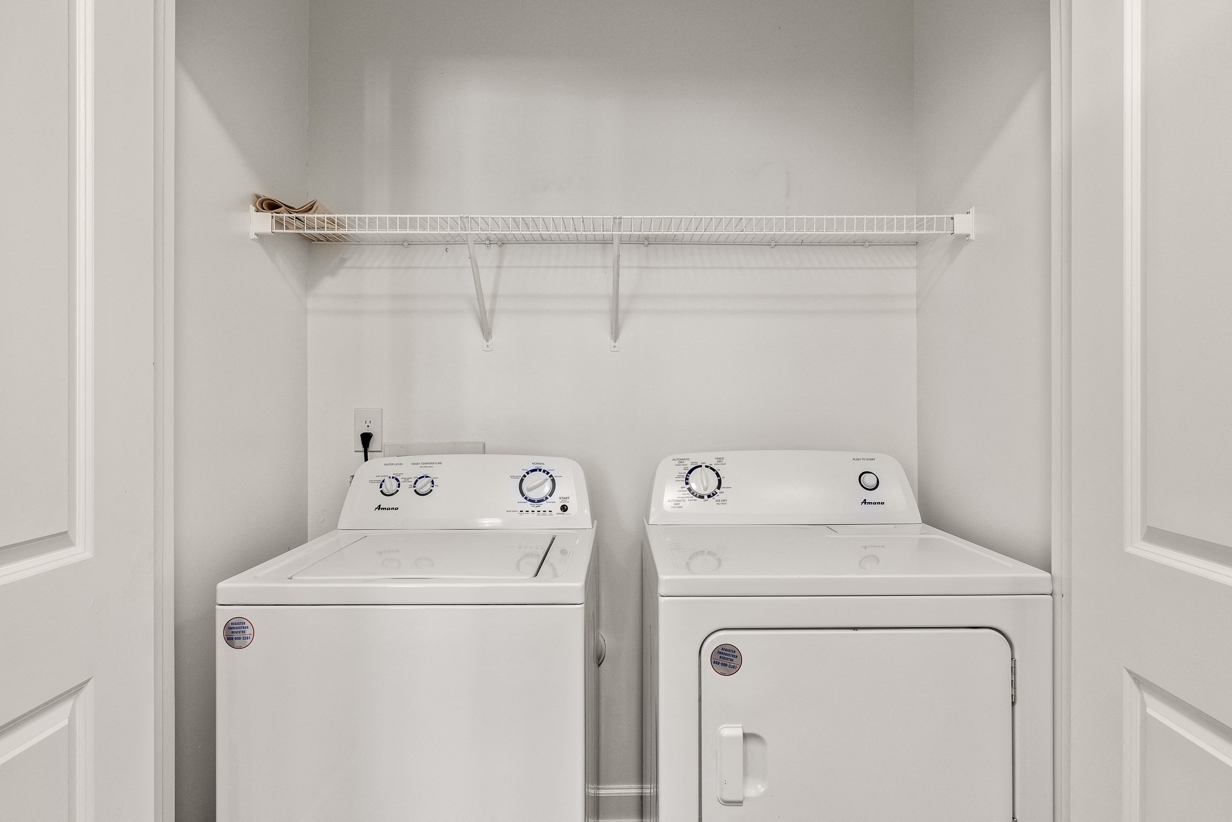 a washer and dryer in a white laundry room